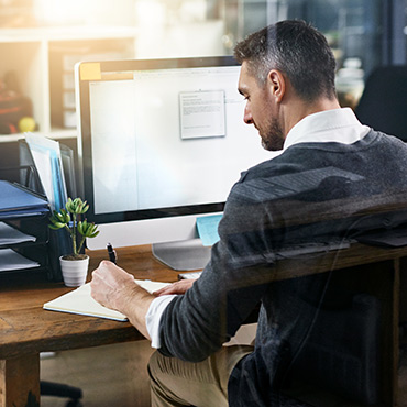 Man working at desk in front of computer.